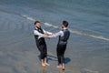 Happy male gay couple with flowers holding hands on wedding. Romantic and sensual gay couple. Gay grooms walking Royalty Free Stock Photo