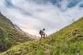 Happy male hiker trekking climbing a mountain. Effort and achievement concept. Royalty Free Stock Photo