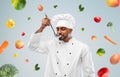 Happy male indian chef tasting food from ladle Royalty Free Stock Photo