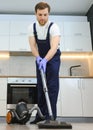 Happy Male Janitor Cleaning Carpet With Vacuum Cleaner Royalty Free Stock Photo