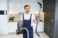 Happy Male Janitor Cleaning Carpet With Vacuum Cleaner Royalty Free Stock Photo