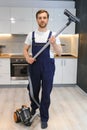 Happy Male Janitor Cleaning Carpet With Vacuum Cleaner Royalty Free Stock Photo