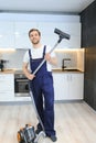 Happy Male Janitor Cleaning Carpet With Vacuum Cleaner Royalty Free Stock Photo