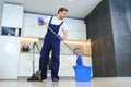 Happy Male Janitor Cleaning Carpet With Vacuum Cleaner Royalty Free Stock Photo