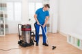 Male Janitor Vacuuming Floor Royalty Free Stock Photo