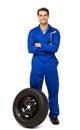 Happy Male Mechanic With Spare Tire