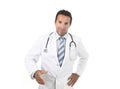 Happy male medicine doctor with stethoscope wearing medical gown standing proud shaking hand Royalty Free Stock Photo