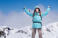 Happy male mountaineer man with raised arms. In background high mountains above clouds . Royalty Free Stock Photo