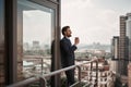Happy male in office suit standing on balcony Royalty Free Stock Photo