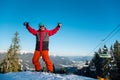 Snowboarder resting on top of the mountain