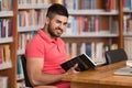 Happy Male Student With Laptop In Library Royalty Free Stock Photo