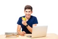 Happy male student sitting at the table with laptop Royalty Free Stock Photo