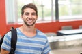 Happy male student standing in the classroom Royalty Free Stock Photo