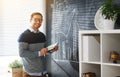 Happy male student, teacher, freelancer with chalk at blackboard Royalty Free Stock Photo