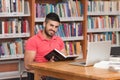 Happy Male Student Working With Laptop In Library Royalty Free Stock Photo