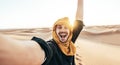 Happy male tourist taking selfie on sand dunes in the Africa desert, Sahara National Park Royalty Free Stock Photo