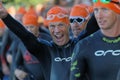 Happy male triathlete smiling and making victory sign