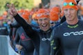 Happy male triathlete smiling and making victory sign