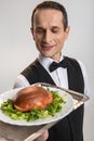 Happy male waiter looking at the sandwich