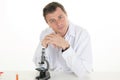 Happy male wearing lab coat while sitting in clinic Royalty Free Stock Photo