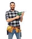 Happy male worker or builder with drill and tools Royalty Free Stock Photo
