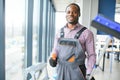 Happy Male Worker Cleaning Glass With Squeegee And Spray Bottle Royalty Free Stock Photo