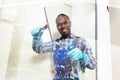 Male Worker Cleaning Glass With Squeegee Royalty Free Stock Photo