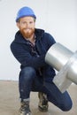 happy male worker fixing ceiling air duct Royalty Free Stock Photo