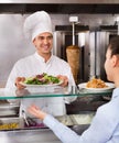 Happy male worker serving customer with smile at shawarma Royalty Free Stock Photo