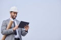 Happy man, architect and tablet on mockup in construction planning on a studio background. Person, engineer or