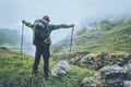Happy Man backpacker hiking in foggy mountains Royalty Free Stock Photo