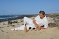 Happy man on the beach has two glasses of red wine Royalty Free Stock Photo