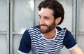 Happy man with beard and striped shirt smiling