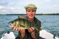 Happy man with big perch fishing trophy