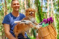 Happy man on bike with his dog in basket and tulips in the park. Royalty Free Stock Photo