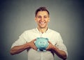 Happy man with blue piggy bank Royalty Free Stock Photo
