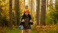 Happy man and a boy go hiking in autumn forest with backpack for hiking. Slow motion portrait smiling father and son Royalty Free Stock Photo