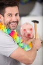 happy man breaking piggy bank with hammer Royalty Free Stock Photo