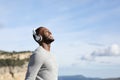 Happy man breathing listening to music outdoors Royalty Free Stock Photo