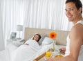 Happy man bringing the breakfast on the bed Royalty Free Stock Photo