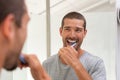 Happy man brushing teeth Royalty Free Stock Photo