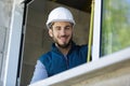 happy man builder infront window with tape measure Royalty Free Stock Photo