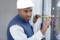 happy man builder infront window with tape measure Royalty Free Stock Photo