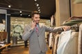 Happy man calling on smartphone at clothing store Royalty Free Stock Photo