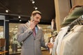 Happy man calling on smartphone at clothing store Royalty Free Stock Photo