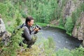 Happy man with camera on the top of taiga forest. Royalty Free Stock Photo