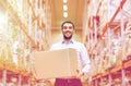 Happy man with cardboard parcel box at warehouse