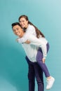 Happy man carrying his girlfriend on the back on blue background Royalty Free Stock Photo