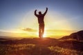 Happy man celebrating winning success against sunset