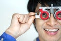 Happy man checking vision with eye test glasses during a medical examination at the ophthalmological office, Checking eye vision Royalty Free Stock Photo